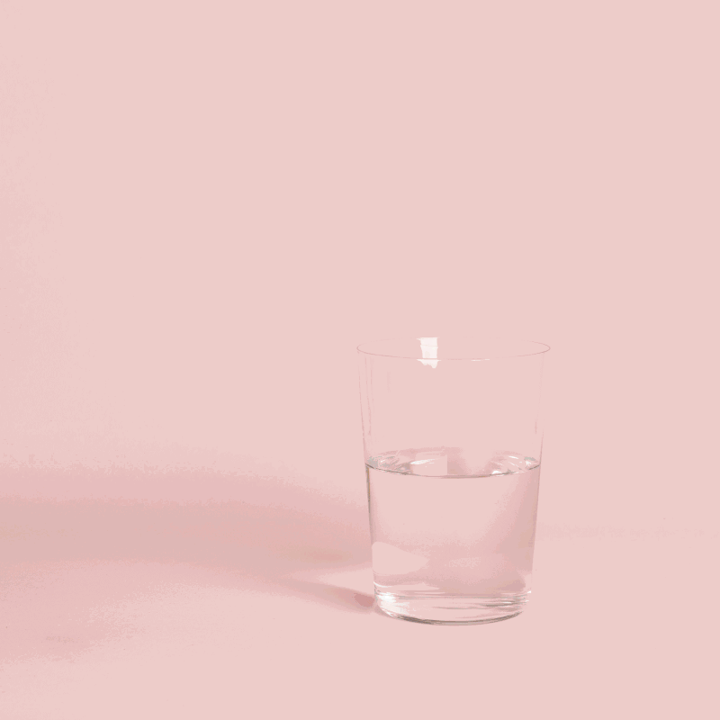 GIF of Fertile You Elixir stirred with pink backdrop.